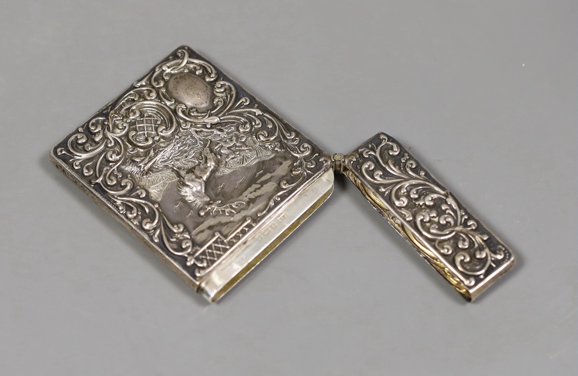 An Edwardian embossed silver card case, decorate d with stag in highland scene, Crisford & Norris, Birmingham 1903, 10.1cm.